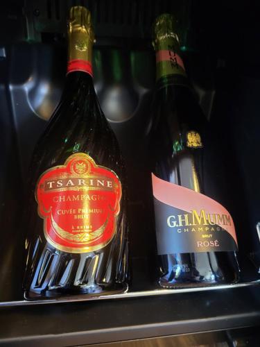 two bottles of wine on a shelf in a refrigerator at les Cachottiers Montélimar in Montélimar