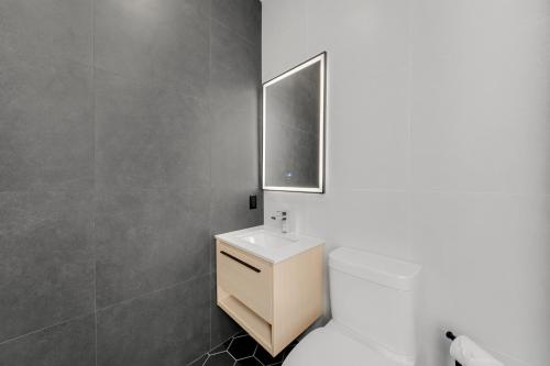 a bathroom with a white toilet and a sink at Lift Hotel in Montréal