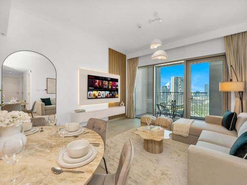 a living room with a couch and a table at Blissful Stays - Luxury Two Bedroom Apartment at Downtown Views II- 5 min walk to Dubai Mall, Burj Khalifa with Infinity Pool in Dubai