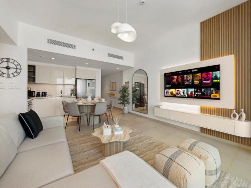 a living room with a couch and a dining room at Blissful Stays - Luxury Two Bedroom Apartment at Downtown Views II- 5 min walk to Dubai Mall, Burj Khalifa with Infinity Pool in Dubai