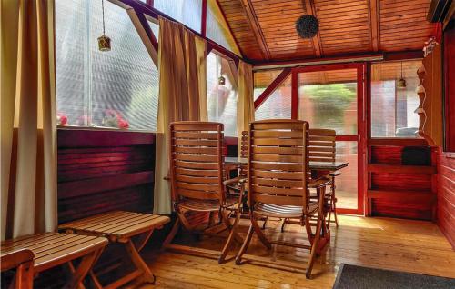 a room with three chairs and a table and a window at 2 Bedroom Amazing Home In Wilcze in Wilcze