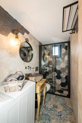 a bathroom with a sink and a shower at The Dona House in Vaia