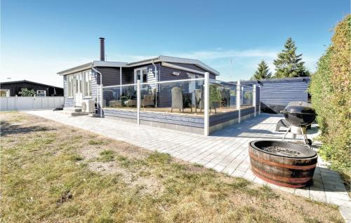 a house with a grill on a patio at Three-Bedroom Holiday Home In Nyborg in Nyborg
