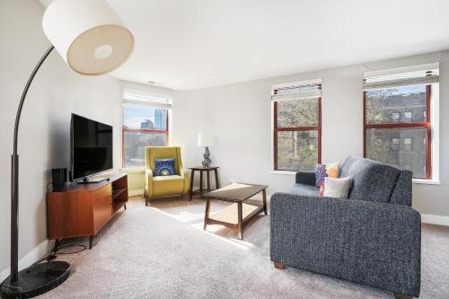 a living room with a couch and a tv at Corner view close to Gainsbridge and Lucas Oil in Indianapolis