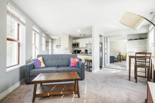 a living room with a couch and a table at Corner view close to Gainsbridge and Lucas Oil in Indianapolis