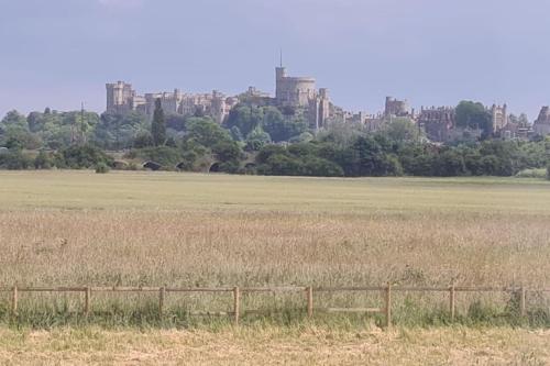 a field with a city in the background at Family home, view of Windsor Castle in Dorney