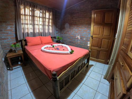 a bedroom with a bed with a cake on it at Congos Lodge in El Perú
