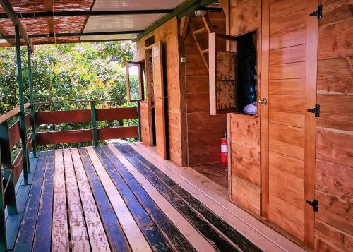 a porch of a wooden cabin with wooden floors at L'Auberge Polynésienne in Tevaitoa