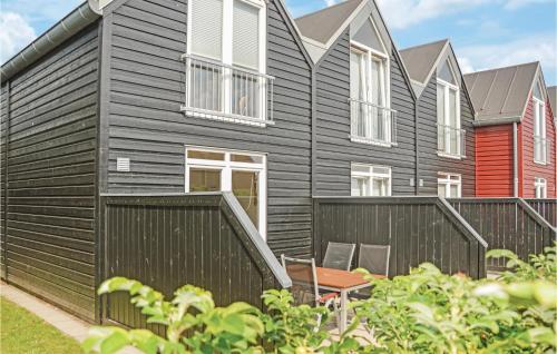 a black house with a black fence at Apartment Norre Nebel 306 in Nørre Nebel