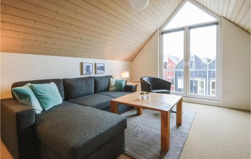 a living room with a couch and a table at Apartment Norre Nebel 306 in Nørre Nebel