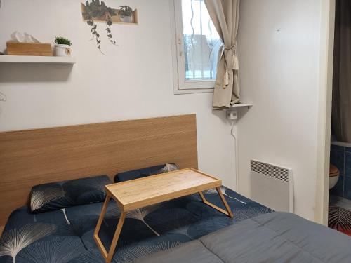 a bedroom with a bed with a table on it at Kedge 9 - proche centre, tram & universités in Talence