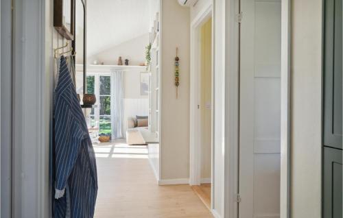 a hallway with a tie hanging on a door at 3 Bedroom Stunning Home In Rødby in Rødby