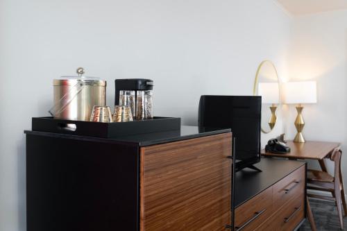 a hotel room with a desk with a coffee maker on it at Sapphire Motel Midtown Bozeman in Bozeman