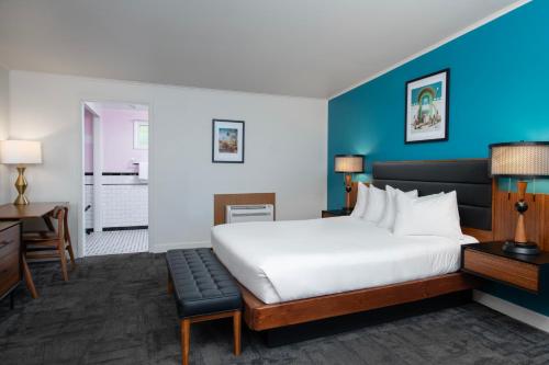 a hotel room with a bed and a desk at Sapphire Motel Midtown Bozeman in Bozeman