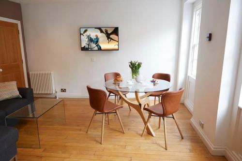 a dining room with a white table and chairs at Jack's Place - Central 2 bedroom apartment in Bath