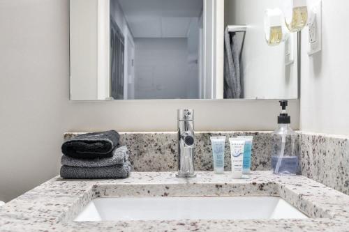 a bathroom with a sink and a mirror at Corner view close to Gainsbridge and Lucas Oil in Indianapolis