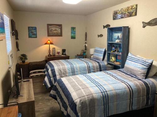 a bedroom with two beds and a living room at Hidden Haven in Canyon Lake