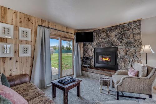 a living room with a fireplace and a couch at Knapsack in Clark