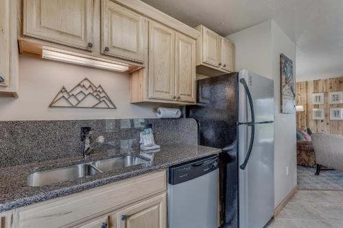 a kitchen with a sink and a refrigerator at Knapsack in Clark