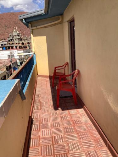 a red chair sitting on a balcony with a cruise ship at Rovira Viajes y Turismo in Tupiza
