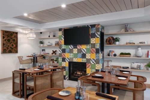 a dining room with tables and a fireplace at The Wave at Marblehead in Marblehead
