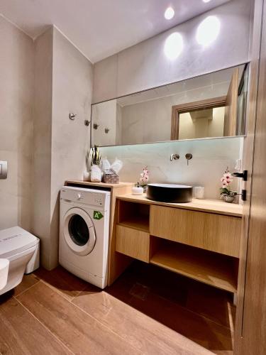 a bathroom with a washing machine and a sink at Central Studio Semi-basement in Heraklio