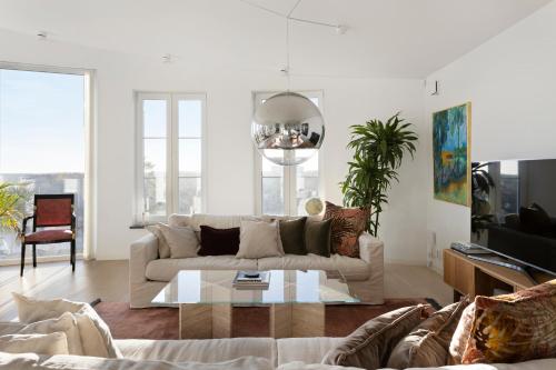 a living room with a couch and a coffee table at Luxury Villa - Private Pool and Lake View in Nacka