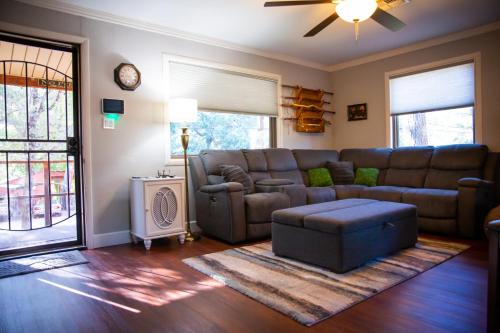 a living room with a couch and a table at Peaceful Pine Place Cabin in Pine