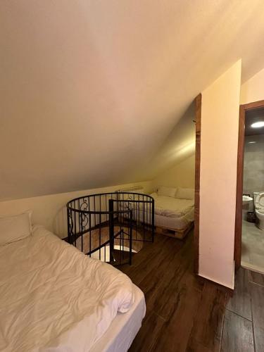 a room with two beds and a table and a mirror at Rokwood faraya in Ash Sha‘rah