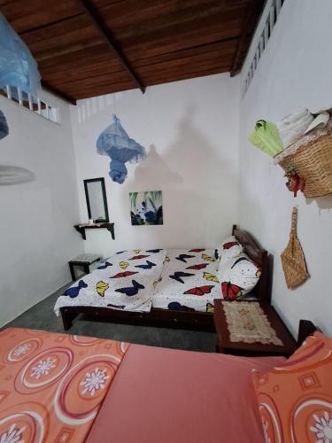 a bedroom with a bed and a couch in it at Alojamiento Casa de campo los Cactus in Villavieja