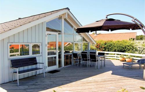 una terraza con sombrilla, mesa y sillas en Holiday Home Hvedemarken Xii, en Hejls