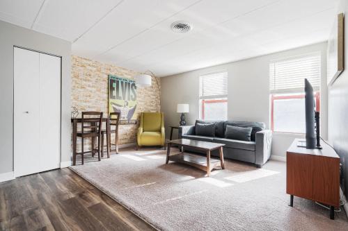 a living room with a couch and a table at Modern Mass Ave 1BR Apartment with Kitchen in Indianapolis