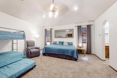 a bedroom with a bed and a chair at Tranquility on Eden in Laredo