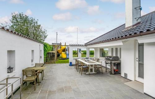 a patio with a table and chairs and a playground at Awesome Home In Slagelse With Wifi in Slagelse