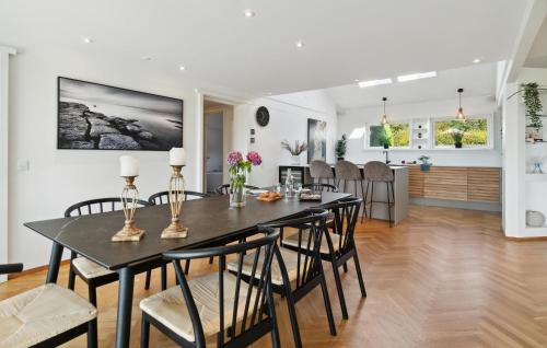a dining room and living room with a table and chairs at Awesome Home In Slagelse With Wifi in Slagelse