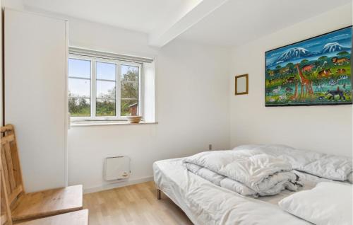 a white bedroom with a bed and a window at Awesome Home In Bredebro With Wifi in Bredebro