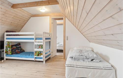 a room with two bunk beds in a attic at Awesome Home In Bredebro With Wifi in Bredebro