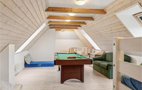 a room with a pool table in a attic at Awesome Home In Bredebro With Wifi in Bredebro