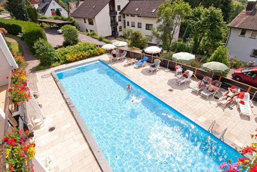 an overhead view of a swimming pool with people in chairs at BSW Schwarzwaldhotel Baiersbronn in Baiersbronn