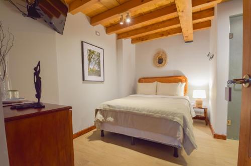 Postel nebo postele na pokoji v ubytování Antiwa Hotel Antigua Guatemala