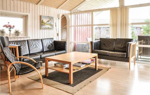 a living room with couches and a coffee table at Holiday Home Strandparken Otterup Ix in Otterup