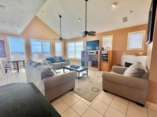 a living room with two couches and a table at Cool Change- Sunset Beach- Beachfront- Pet-Friendly in St. George Island