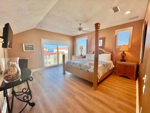 a bedroom with a bed and a balcony at Cool Change- Sunset Beach- Beachfront- Pet-Friendly in St. George Island