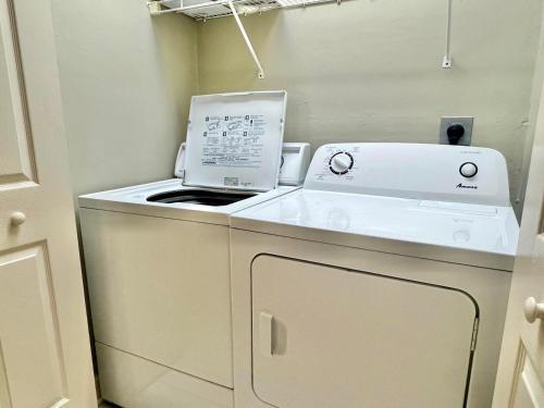 a kitchen with a toaster and a printer on a counter at Cool Change- Sunset Beach- Beachfront- Pet-Friendly in St. George Island
