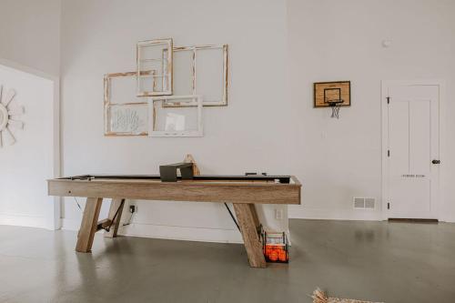a wooden table in a white room with ahibition at Afton Clubhouse in Afton