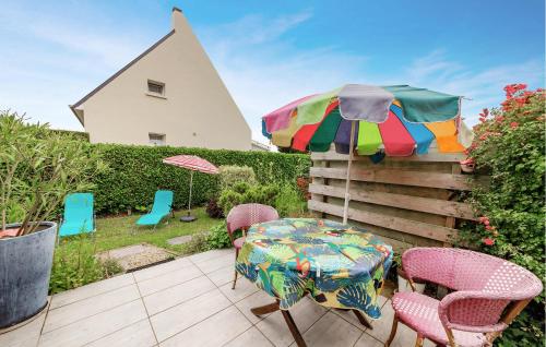 a patio with a table and chairs and an umbrella at Nice Home In Le Minihic-Sur-Rance in Le Minihic-sur-Rance