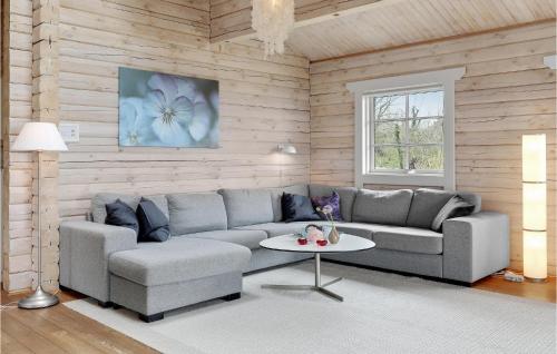 a living room with a couch and a table at 3 Bedroom Gorgeous Home In Hasle in Hasle