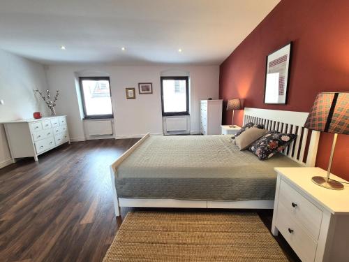 a bedroom with a large bed and red walls at Apartment Zoe - Old Town in Bratislava