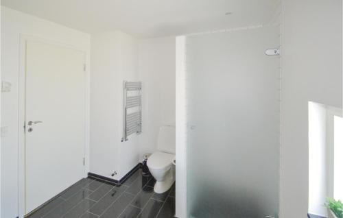 a bathroom with a toilet and a window at Two-Bedroom Holiday Home In Nimtofte in Nimtofte