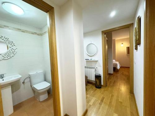 a bathroom with a toilet and a sink and a mirror at Apartamento Alma de Guadalajara with Sun terrace in Guadalajara